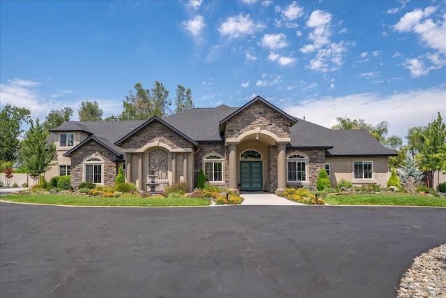 19580 Mockingbird Ln, Redding, CA 96002 - french country style house featuring stone siding, french doors, and stucco siding