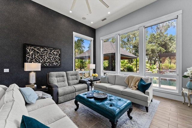 19580 Mockingbird Ln, Redding, CA 96002 - living room with plenty of natural light, light wood-style floors, an accent wall, recessed lighting, and ceiling fan