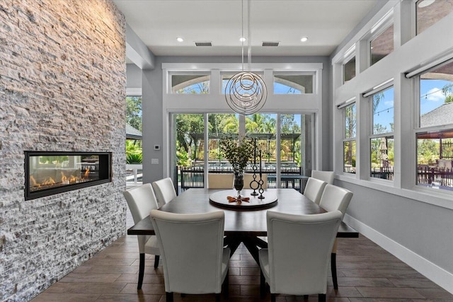 19580 Mockingbird Ln, Redding, CA 96002 - dining space featuring dark wood-type flooring, a fireplace, recessed lighting, and a high ceiling