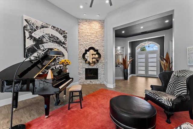 19580 Mockingbird Ln, Redding, CA 96002 - living area featuring wood finished floors, recessed lighting, a stone fireplace, and a ceiling fan