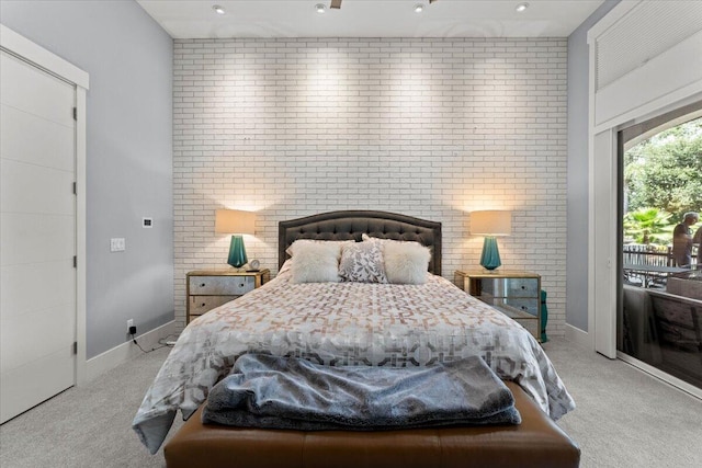 19580 Mockingbird Ln, Redding, CA 96002 - bedroom featuring light carpet, access to exterior, and brick wall