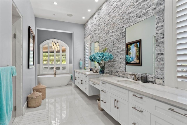 19580 Mockingbird Ln, Redding, CA 96002 - bathroom with plenty of natural light, two vanities, a freestanding tub, tile patterned floors, and recessed lighting
