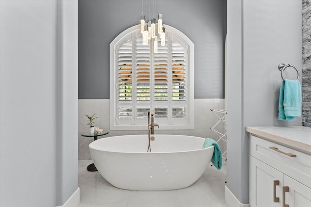 19580 Mockingbird Ln, Redding, CA 96002 - bathroom with tile walls, a freestanding bath, and a wainscoted wall