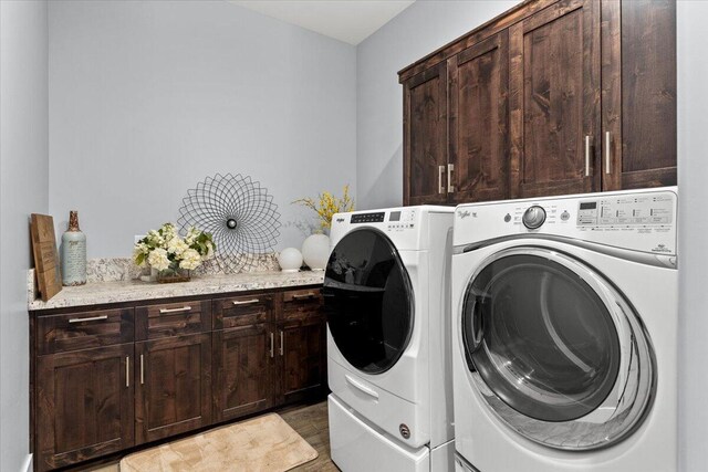 19580 Mockingbird Ln, Redding, CA 96002 - washroom with washer and clothes dryer, cabinet space, and light wood-type flooring