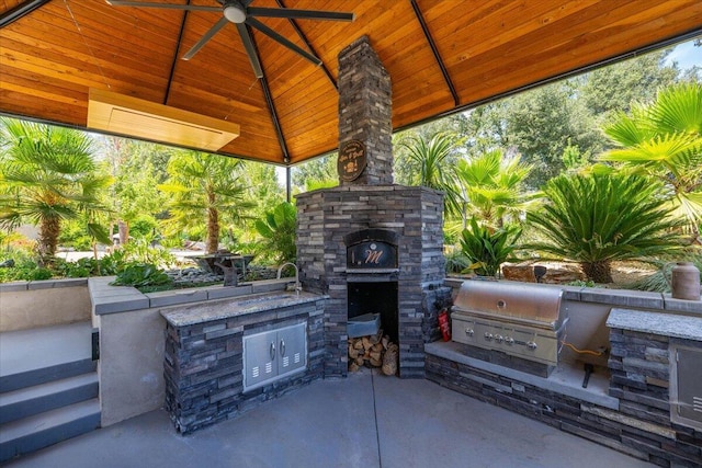 19580 Mockingbird Ln, Redding, CA 96002 - view of patio / terrace featuring exterior kitchen, a gazebo, ceiling fan, and an outdoor stone fireplace