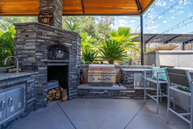19580 Mockingbird Ln, Redding, CA 96002 - view of patio / terrace featuring an outdoor stone fireplace, area for grilling, and an outdoor bar