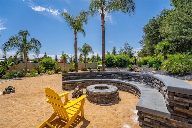 19580 Mockingbird Ln, Redding, CA 96002 - fenced backyard featuring a fire pit and a patio area