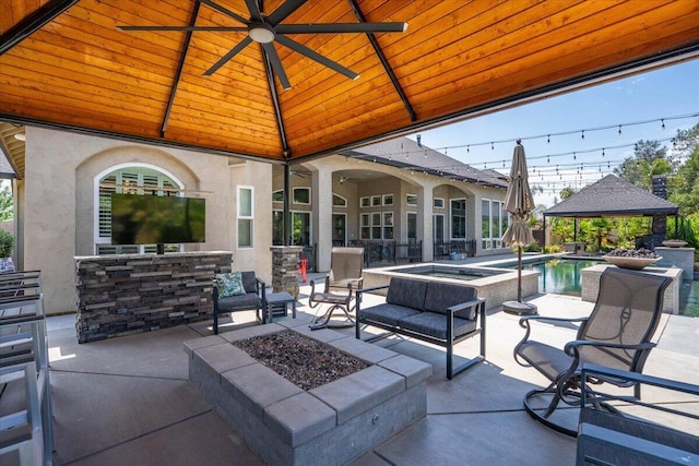 19580 Mockingbird Ln, Redding, CA 96002 - view of patio with a gazebo, an outdoor fire pit, a ceiling fan, and a pool with connected hot tub