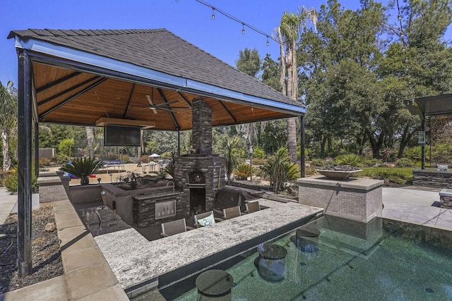 19580 Mockingbird Ln, Redding, CA 96002 - view of patio featuring a gazebo, an outdoor stone fireplace, and ceiling fan
