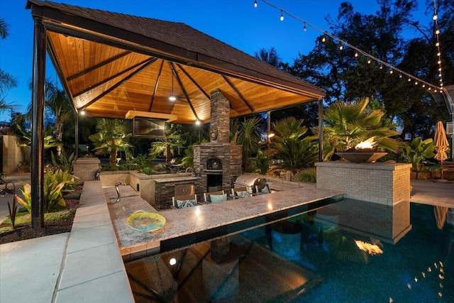 19580 Mockingbird Ln, Redding, CA 96002 - pool at night with a gazebo, area for grilling, and a patio