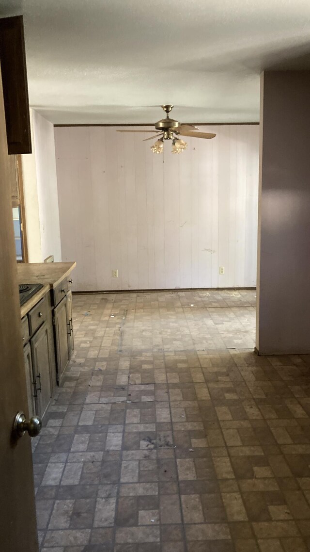770 Day Rd, Mcarthur, CA 96056 - unfurnished dining area with a ceiling fan, brick patterned flooring, and wooden walls