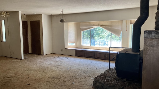 770 Day Rd, Mcarthur, CA 96056 - living room featuring a wood stove and light carpet