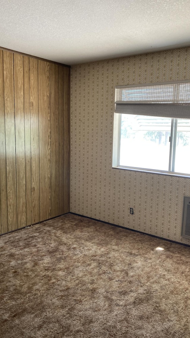 770 Day Rd, Mcarthur, CA 96056 - unfurnished room featuring carpet flooring, a textured ceiling, and wallpapered walls