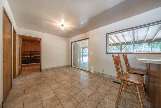 37347 Cypress Ave, Burney, CA 96013 - unfurnished dining area with light tile patterned flooring and a bar