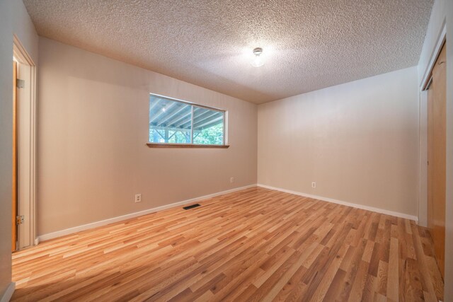37347 Cypress Ave, Burney, CA 96013 - unfurnished room featuring wood finished floors and a textured ceiling