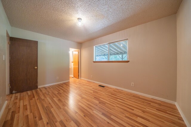 37347 Cypress Ave, Burney, CA 96013 - empty room with light wood finished floors and a textured ceiling