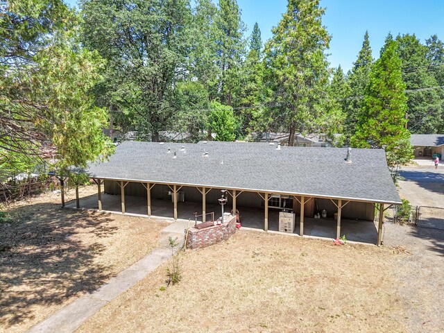 37347 Cypress Ave, Burney, CA 96013 - view of front of house featuring an exterior structure, roof with shingles, an outdoor structure, and view of scattered trees