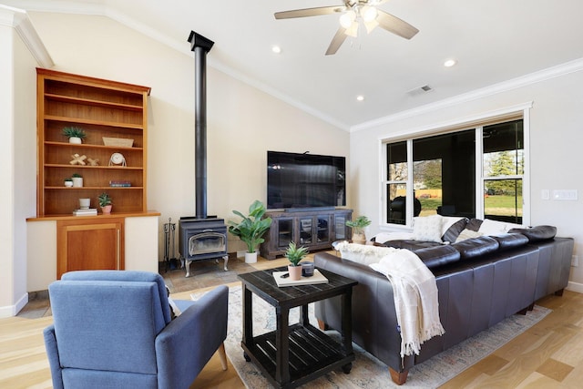 3010 Mateo Ct, Anderson, CA 96007 - living room with a wood stove, vaulted ceiling, ceiling fan, light wood-style floors, and recessed lighting
