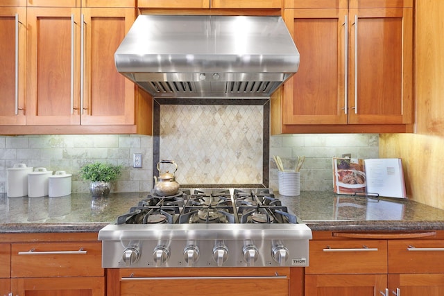 3010 Mateo Ct, Anderson, CA 96007 - kitchen with exhaust hood, stainless steel gas cooktop, brown cabinetry, and backsplash