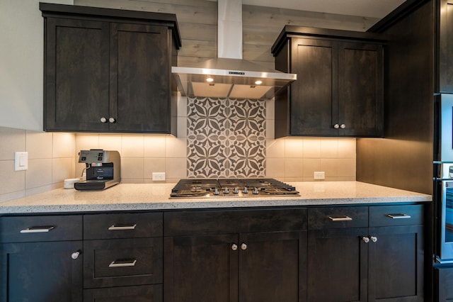 6538 Bandito Dr, Redding, CA 96003 - kitchen featuring wall chimney range hood, appliances with stainless steel finishes, backsplash, and dark brown cabinetry