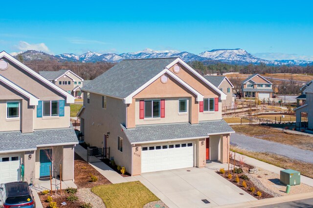 6538 Bandito Dr, Redding, CA 96003 - traditional-style home featuring stucco siding, a mountain view, a garage, driveway, and a residential view