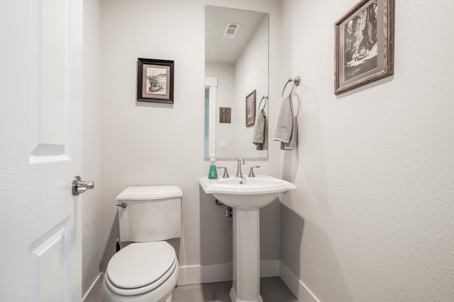 6538 Bandito Dr, Redding, CA 96003 - half bath featuring toilet and wood finished floors