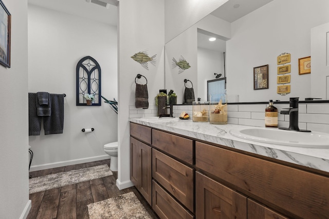 18710 Saddleback Ridge Rd, Cottonwood, CA 96022 - bathroom featuring wood finished floors, double vanity, and tasteful backsplash