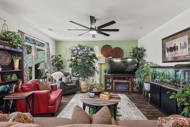 18710 Saddleback Ridge Rd, Cottonwood, CA 96022 - living room featuring ceiling fan, wood finished floors, and a warm lit fireplace