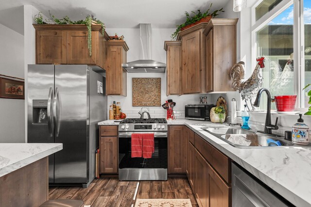 18710 Saddleback Ridge Rd, Cottonwood, CA 96022 - kitchen with wall chimney exhaust hood, appliances with stainless steel finishes, dark wood-style floors, and brown cabinetry