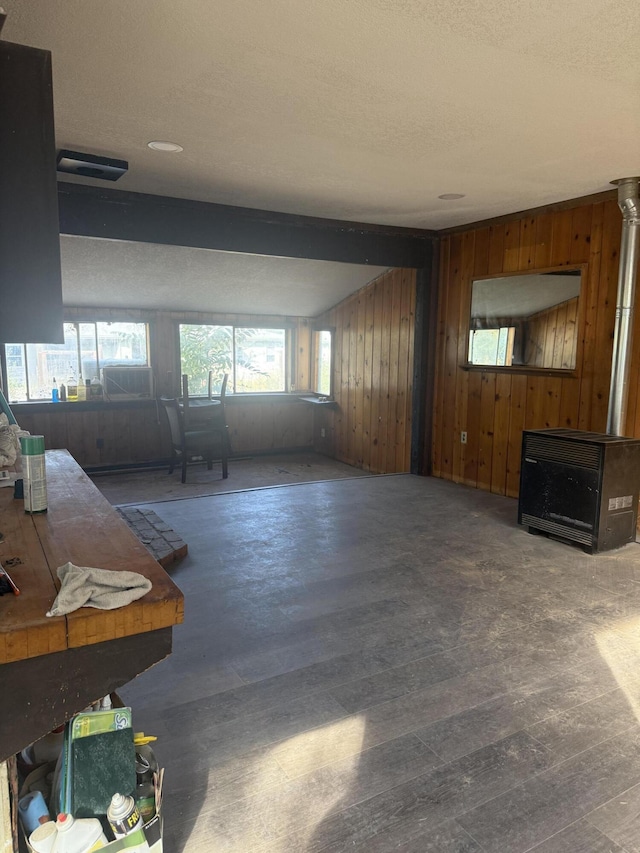 3400 Beacon Dr, Anderson, CA 96007 - living room with wooden walls, wood finished floors, heating unit, and a textured ceiling