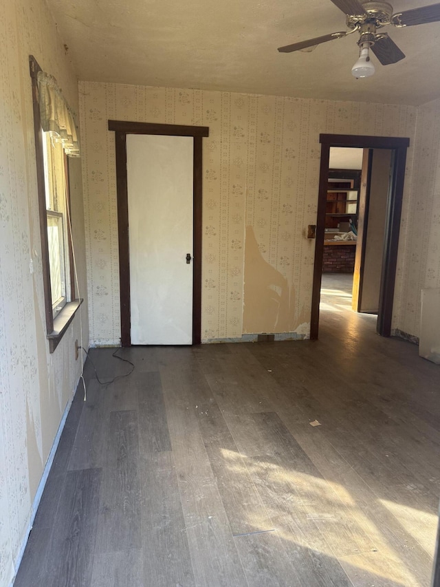 3400 Beacon Dr, Anderson, CA 96007 - spare room with wallpapered walls, wood finished floors, and a ceiling fan