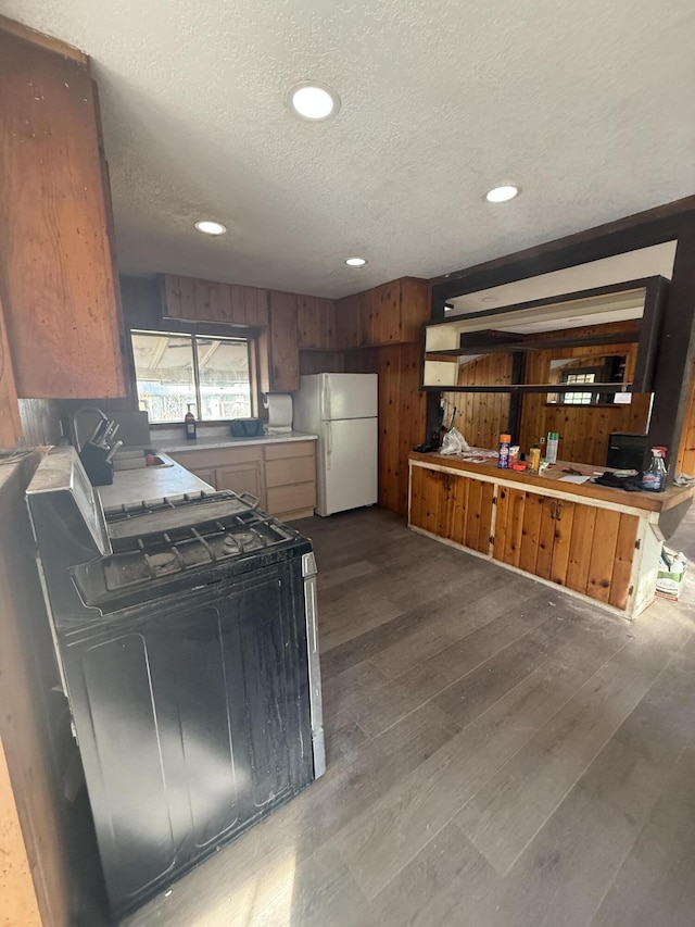 3400 Beacon Dr, Anderson, CA 96007 - kitchen featuring freestanding refrigerator, gas stove, a textured ceiling, dark wood-type flooring, and recessed lighting