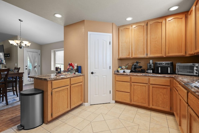 1870 Trumpet Dr, Redding, CA 96003 - kitchen with a peninsula, a chandelier, lofted ceiling, hanging light fixtures, and recessed lighting
