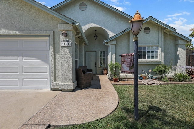 1870 Trumpet Dr, Redding, CA 96003 - view of front facade featuring an attached garage, stucco siding, concrete driveway, and a front lawn