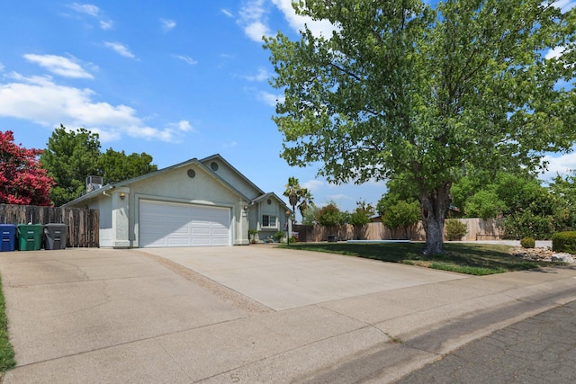 1870 Trumpet Dr, Redding, CA 96003 - ranch-style home featuring a garage, stucco siding, and driveway