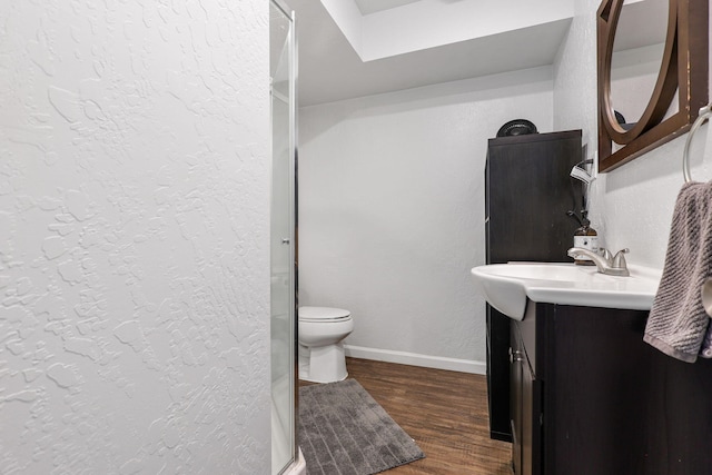 1575 Fig Ave, Redding, CA 96001 - full bathroom with vanity, wood finished floors, a textured wall, and a shower stall