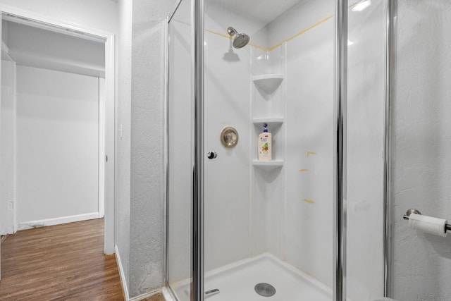 1575 Fig Ave, Redding, CA 96001 - full bathroom featuring a shower stall, wood finished floors, and a textured wall