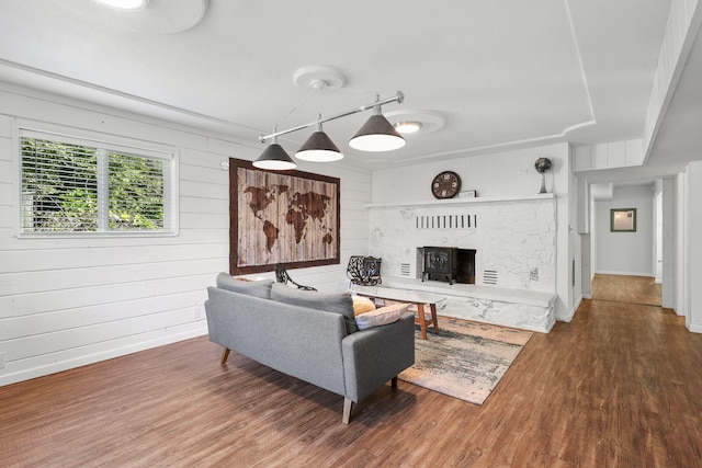 1575 Fig Ave, Redding, CA 96001 - living area with a fireplace with raised hearth, wood finished floors, and wooden walls