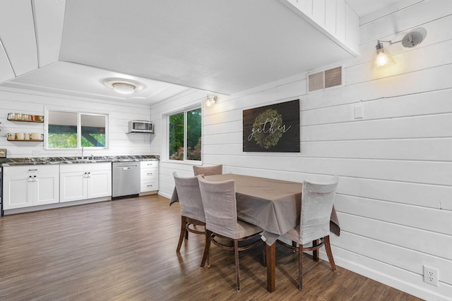 1575 Fig Ave, Redding, CA 96001 - dining area with dark wood-style flooring, wood walls, and a wall mounted air conditioner