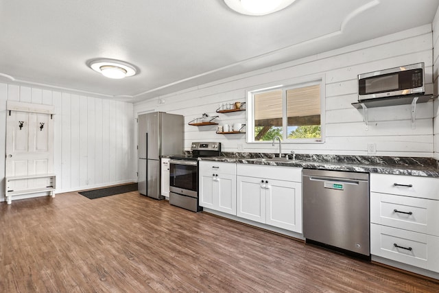 1575 Fig Ave, Redding, CA 96001 - kitchen featuring appliances with stainless steel finishes, wood walls, dark wood-type flooring, open shelves, and white cabinets