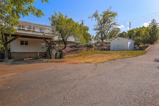 1575 Fig Ave, Redding, CA 96001 - view of side of home featuring a storage shed, a wooden deck, and stairway