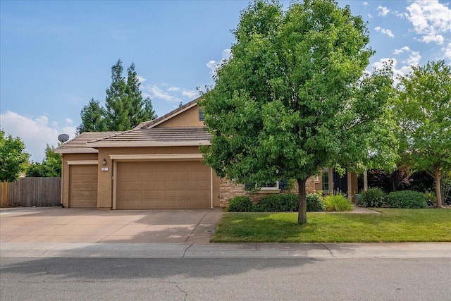 691 Rivercrest Pkwy, Redding, CA 96002 - view of property hidden behind natural elements with concrete driveway, an attached garage, a tile roof, and stucco siding
