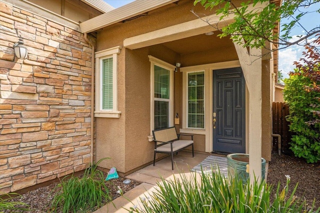 691 Rivercrest Pkwy, Redding, CA 96002 - property entrance featuring stone siding, stucco siding, and covered porch