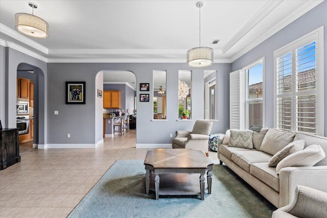691 Rivercrest Pkwy, Redding, CA 96002 - living room featuring arched walkways, light tile patterned floors, and crown molding