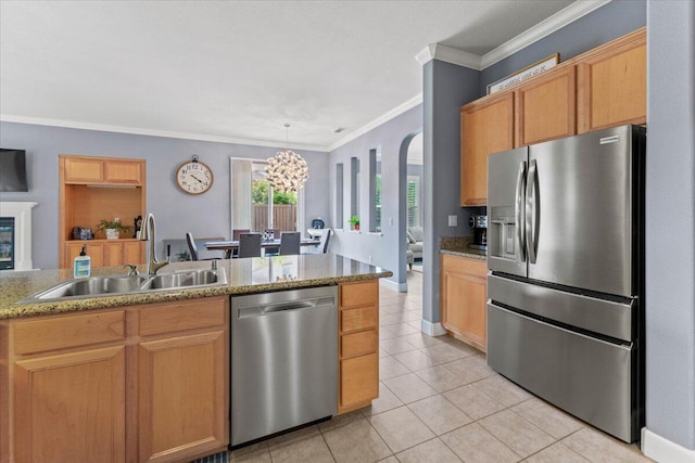 691 Rivercrest Pkwy, Redding, CA 96002 - kitchen with appliances with stainless steel finishes, a chandelier, light tile patterned floors, crown molding, and arched walkways