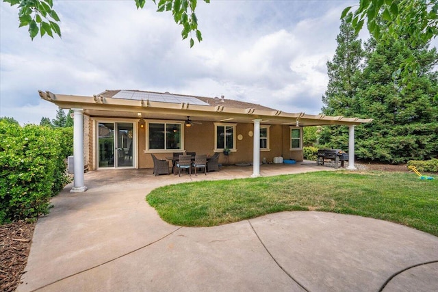 691 Rivercrest Pkwy, Redding, CA 96002 - back of house with ceiling fan, a patio, a lawn, and stucco siding