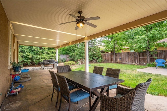 691 Rivercrest Pkwy, Redding, CA 96002 - fenced backyard with a patio area, ceiling fan, and outdoor dining space