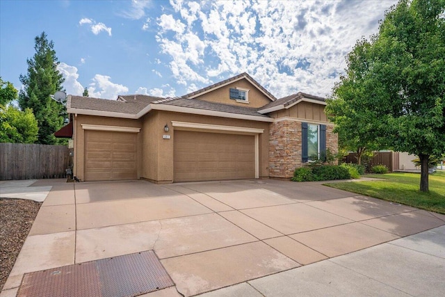 691 Rivercrest Pkwy, Redding, CA 96002 - view of front of home with a garage, a tiled roof, driveway, stone siding, and stucco siding