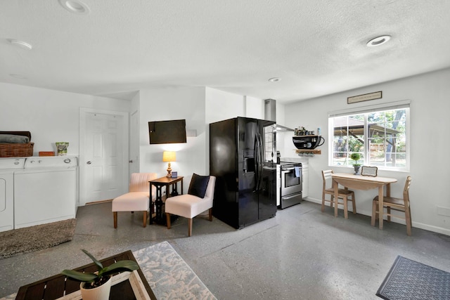 3075 Forest Hills Dr, Redding, CA 96002 - kitchen with washing machine and dryer, black fridge, stainless steel range with electric cooktop, wall chimney range hood, and a textured ceiling