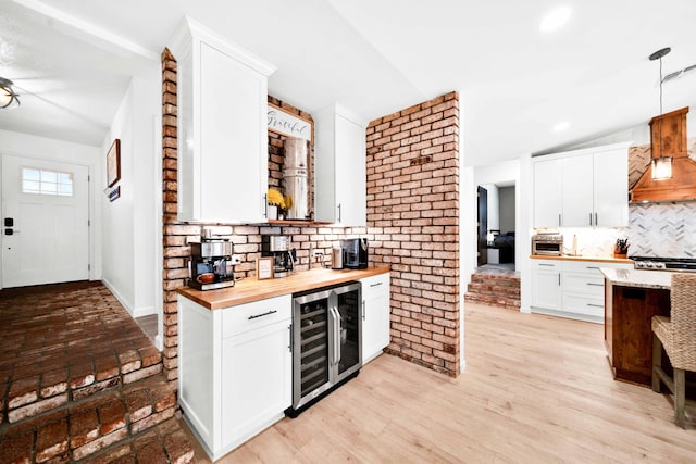3075 Forest Hills Dr, Redding, CA 96002 - kitchen with wine cooler, butcher block counters, tasteful backsplash, white cabinets, and pendant lighting